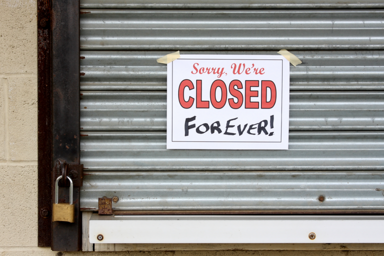 Sign on shuttered building reads Sorry, We're Closed Forever!