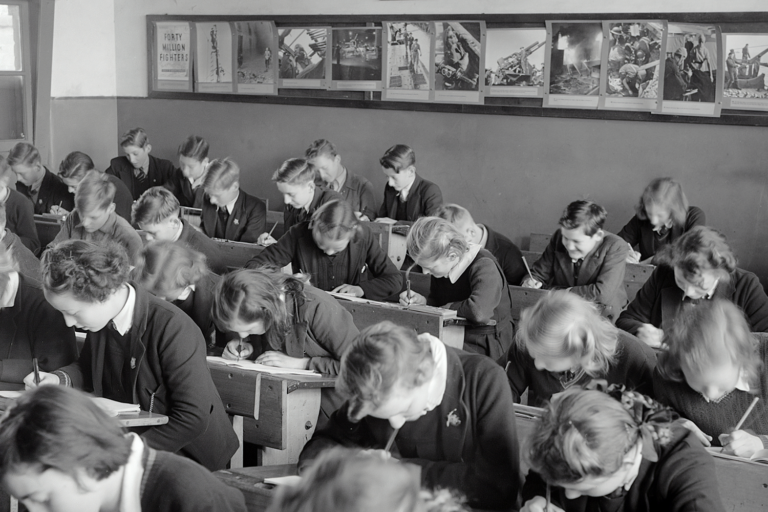 Old image of students taking a test at a Catholic School