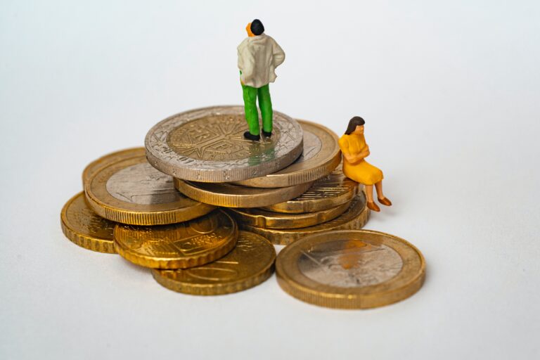 small figurines of people sitting on coins