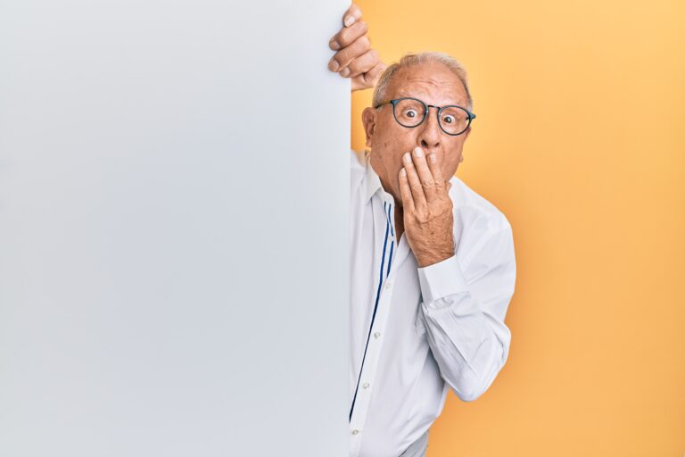 man with glasses holding his hand over mouth