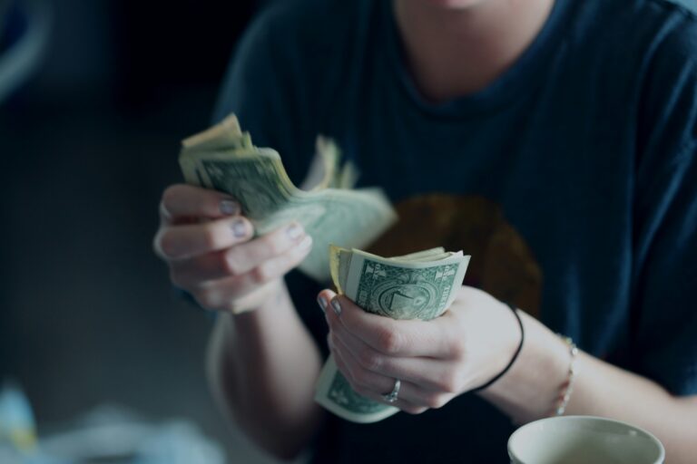 person counting dollar bills