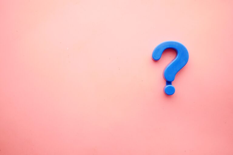 a pink background with a blue question mark