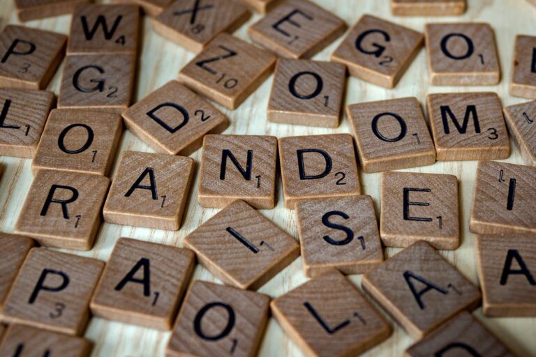 Scrabble tiles on a desk. One section spells out RANDOM