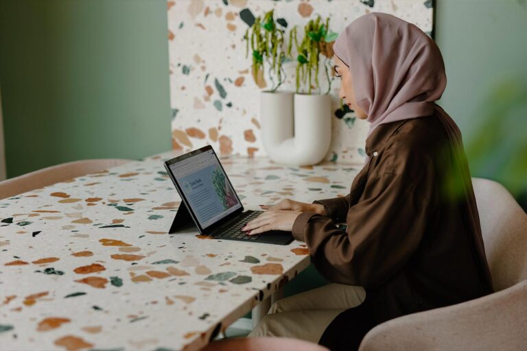 Woman working at a table on a laptop