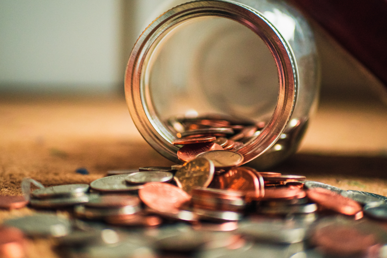 Coins spilling out of a jar