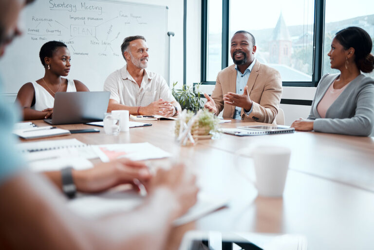 business people sitting around a table talking