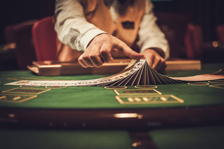 a casino table with a dealer laying out cards