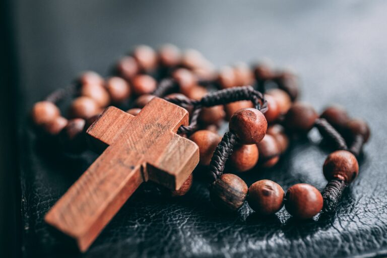 a christian rosary with a wooden cross and wooden beads