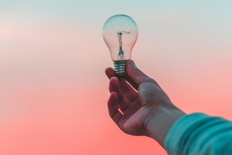 Hand holding a light bulb