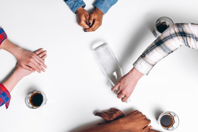 4 friends playing a game of spin the bottle