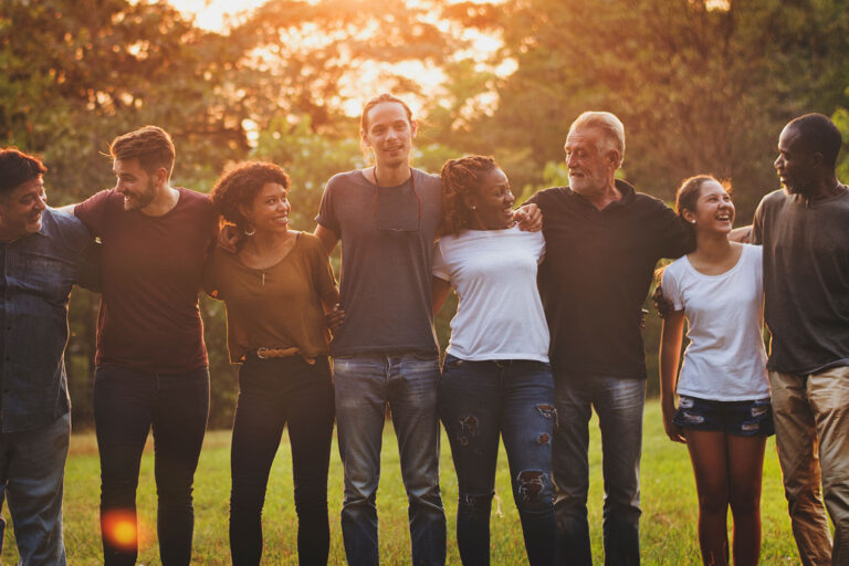 people standing arm in arm outside