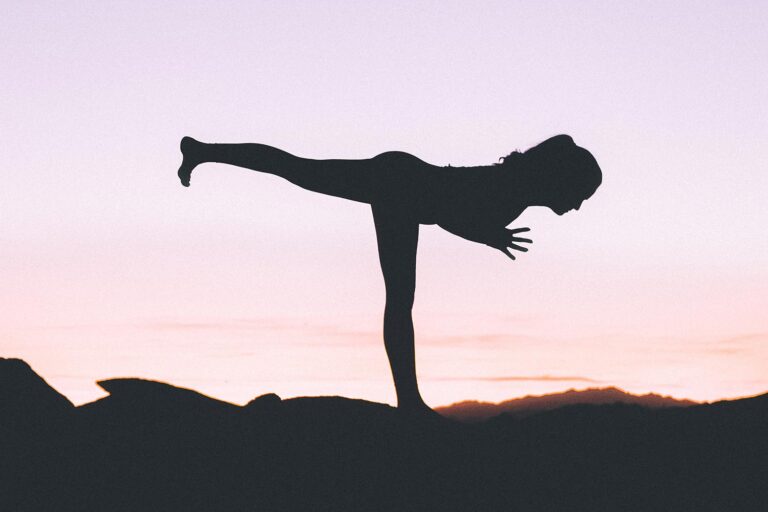 Woman doing yoga pose on one leg