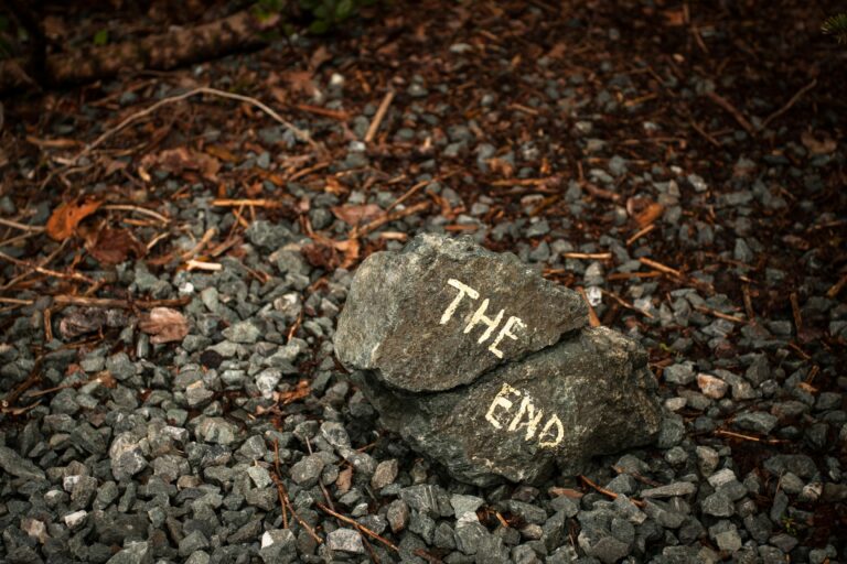 a large stone with the text "The End" written on it with chalk