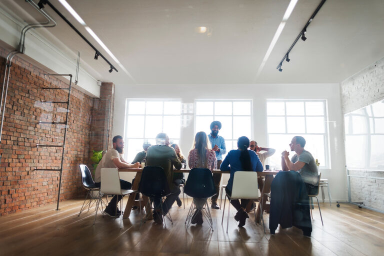 group of people sit around a table