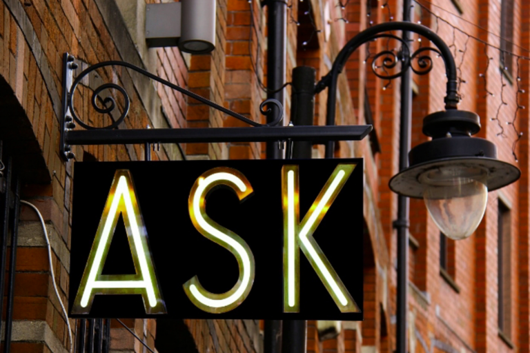 A sign on a building reads ASK