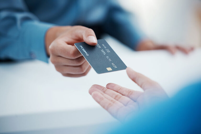 person handing over a credit card