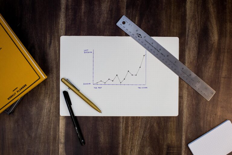 a paper laying on the table showing a upward trend graph