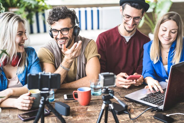 A group of people making web content on cameras and phones