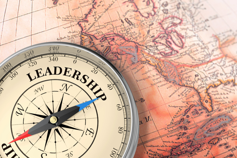 Map with a compass on it that has the word Leadership on it.