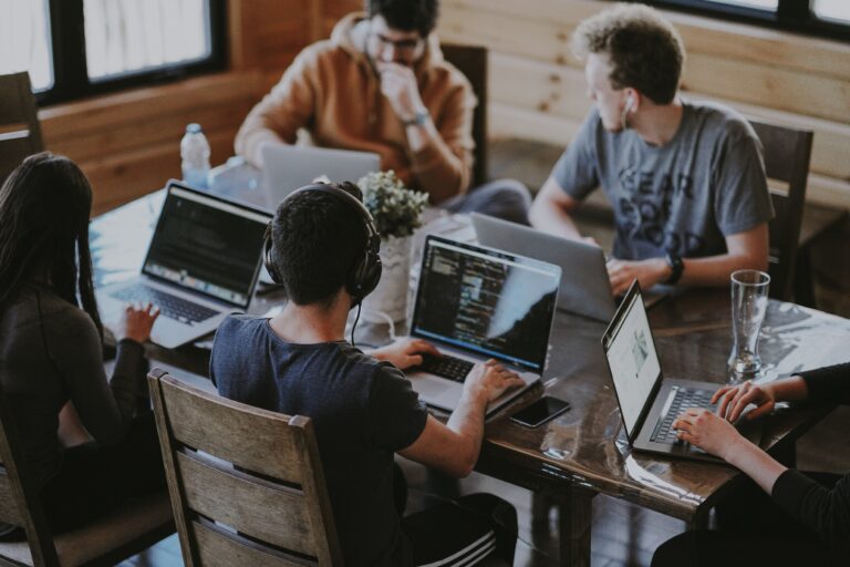 a group of teens sitting at a desk