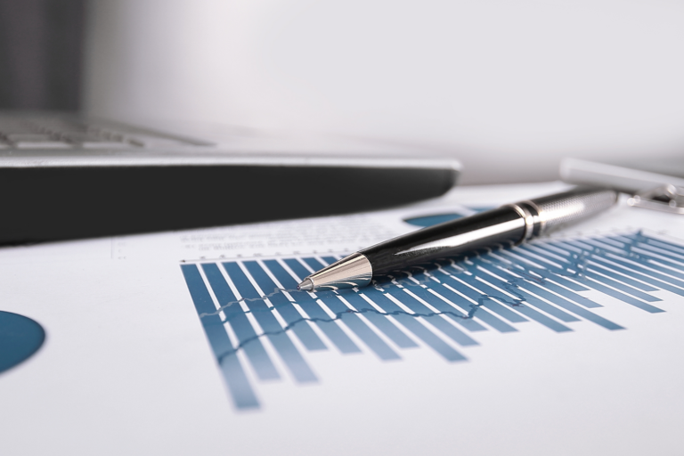 Pen rests on top of a bar graph on a piece of paper