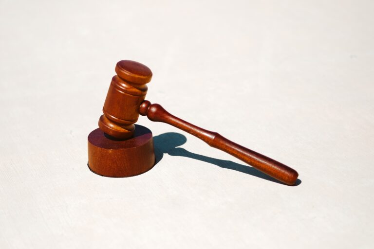 brown wooden court gavel on white surface