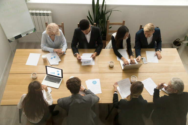 group of business people sitting around a table viewed from above