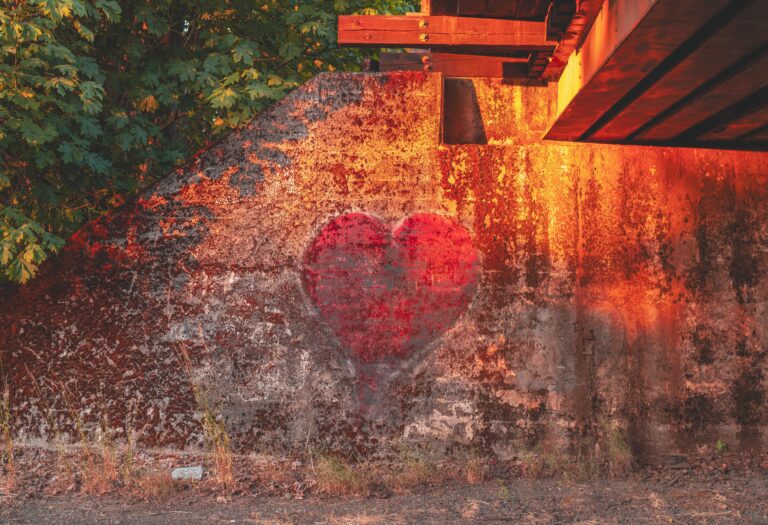 a concrete wall with a heart spray painted on it