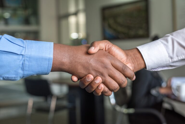 a close up of two people shaking hands