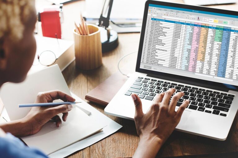 Woman looking at spreadsheet on a laptop