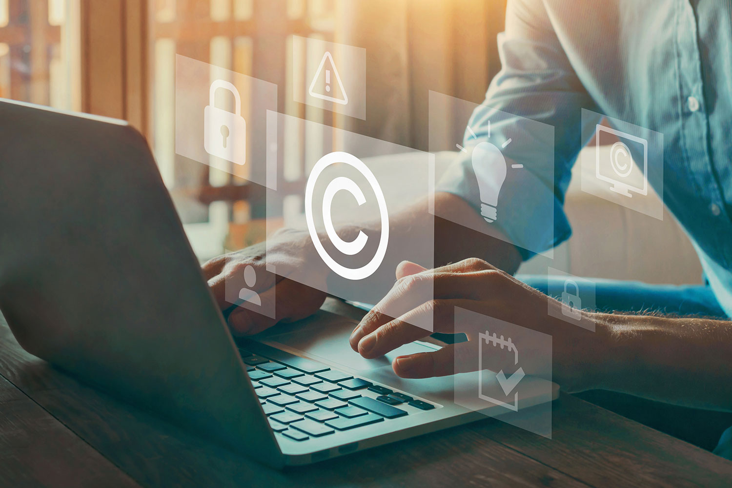 a person using a laptop with copyright symbols showing