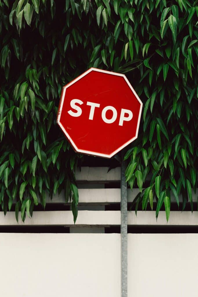 a red stop sign hanging from a tree to illustrate nonprofit fundraising 