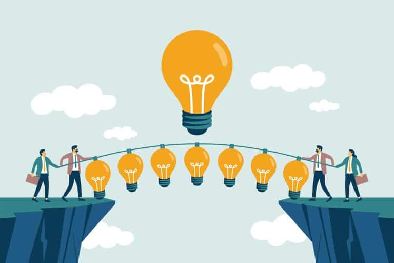 people hanging on a rope with light bulbs on a cliff