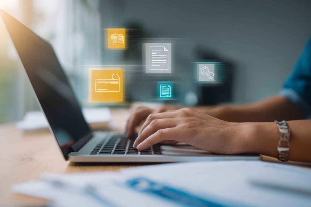 a person typing on a laptop with document graphics