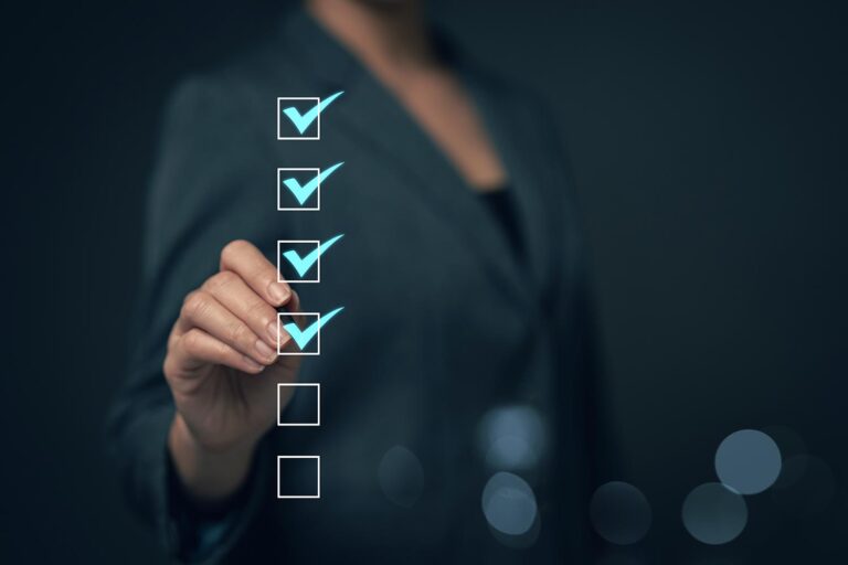 a person checking off items in a list on a glass board