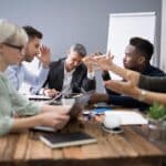 people argueing around a meeting table