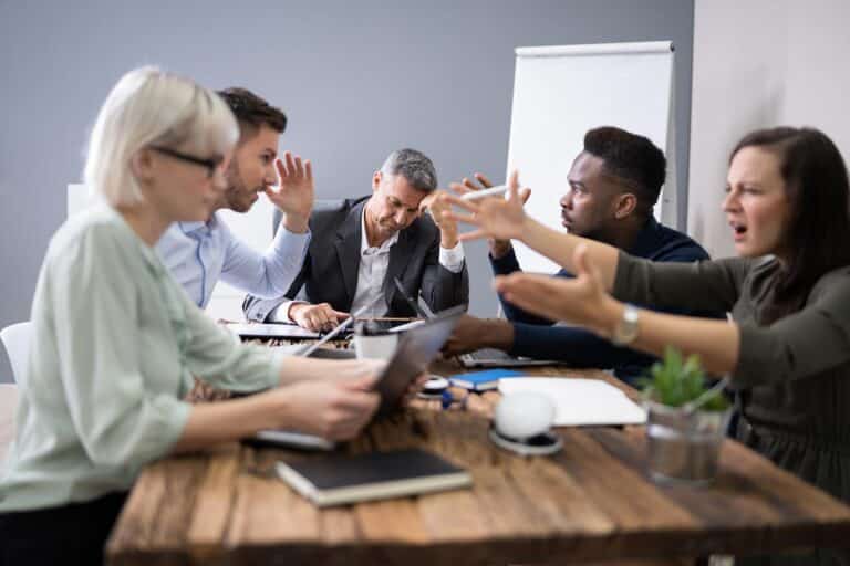 people argueing around a meeting table